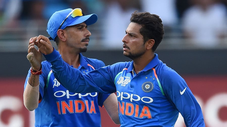 Indian cricketer Kuldeep Yadav (R) and Yuzvendra Chahal (L). Credit: AFP Photo