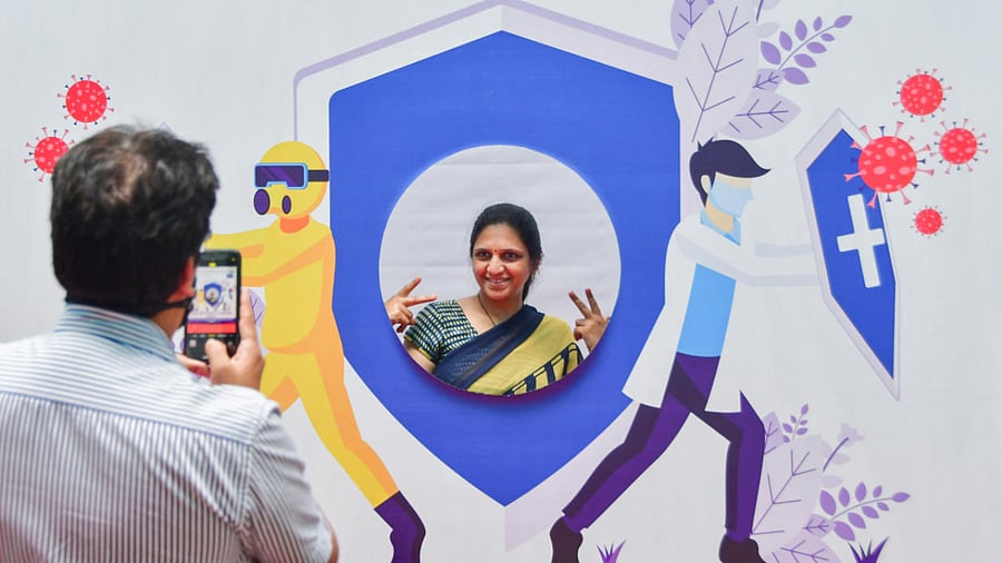 A woman poses for photographs after receiving a dose of Covid-19 vaccine in Mumbai. Credit: PTI Photo