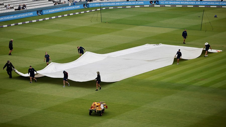 Groundstaff move the covers as rain delays the start of play ahead of the second one day international (ODI) cricket match between England and Pakistan at Lord's cricket ground in London. Credit: AFP Photo