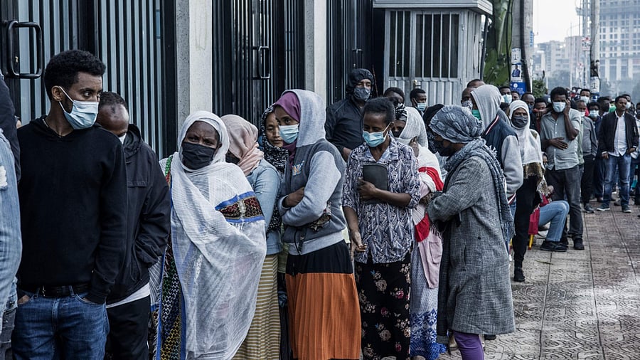 A long queue of voters wait on the sidewalk outside a polling station in Addis Ababa. Credit: AFP Photo