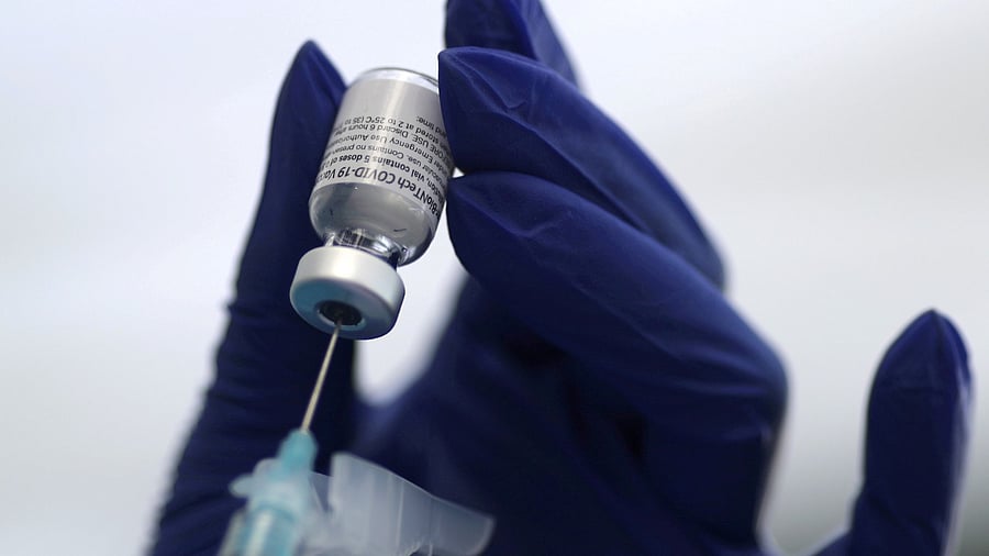 A healthcare worker prepares a Pfizer Covid-19 vaccination. Credit: Reuters Photo