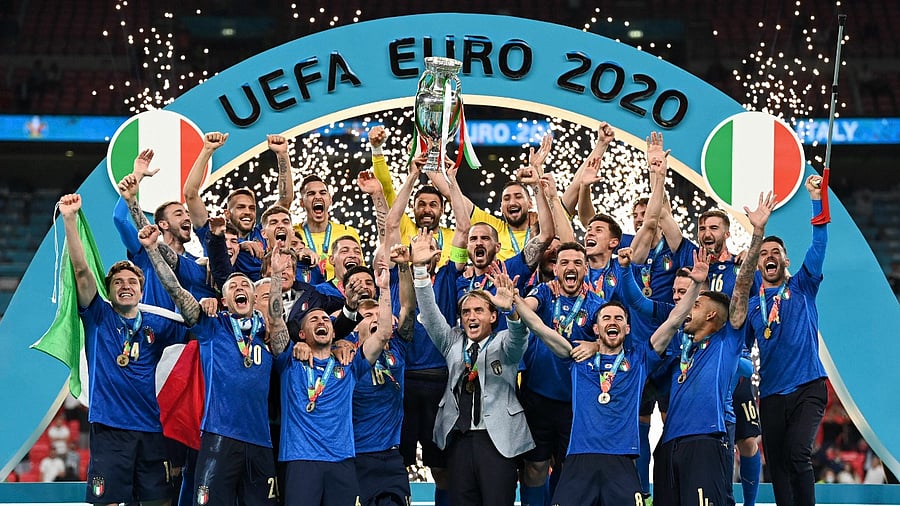 Italy's team celebrates with the Euro 2020 trophy. Credit: AP Photo