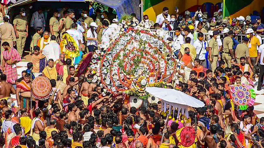 Devotees perform rituals during the annual Rath Yatra festival in Puri. Credit: PTI Photo