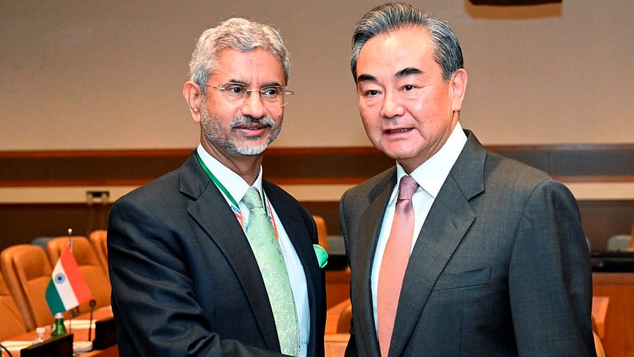External Affairs Minister S Jaishankar shakes hands with Foreign Minister of the People's Republic of China Wang Yi. Credit: PTI Photo