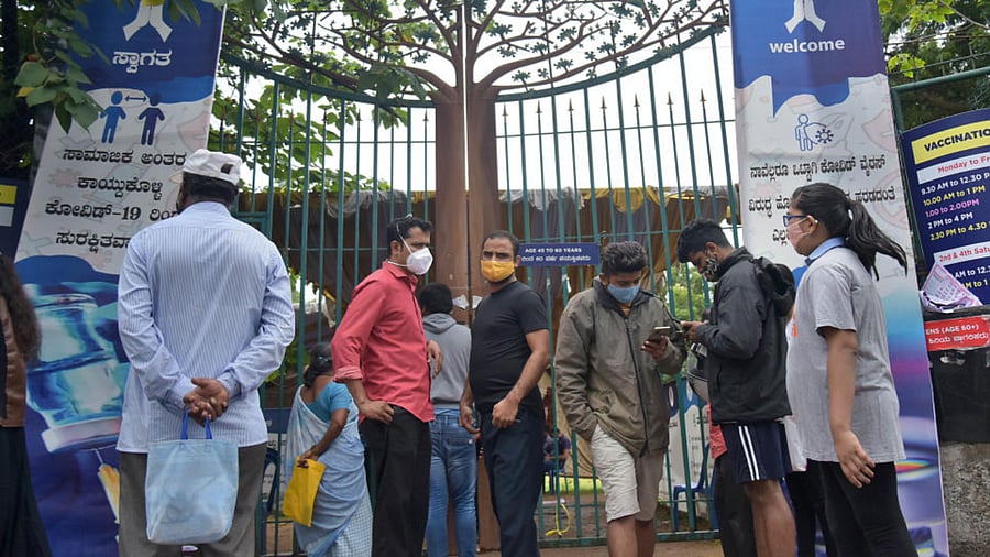 People wait for their turn to get Covid vaccine at a vaccination center near KC General Hospital at Malleswaram in Bengaluru on Tuesday. Credit: DH Photo/PUSHKAR V