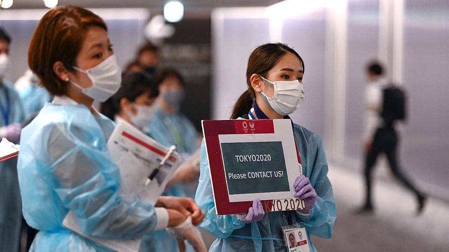 Airport operations crew for the Tokyo 2020 wait for Olympic athletes. Credit: AFP Photo
