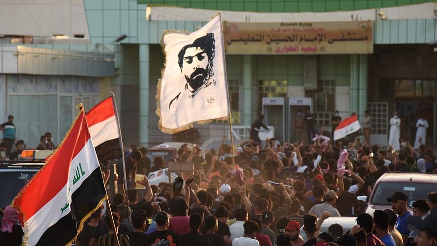 People gather outside Al-Hussain Covid hospital, following a fire that broke out, during a protest in Nassiriya. Credit: Reuters Photo