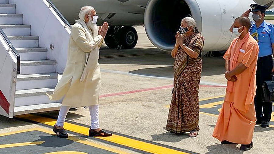 Prime Minister Narendra Modi being welcomed by UP Governor Anandiben Patel and CM Yogi Adityanath, in Varanasi. Credit: PTI Photo