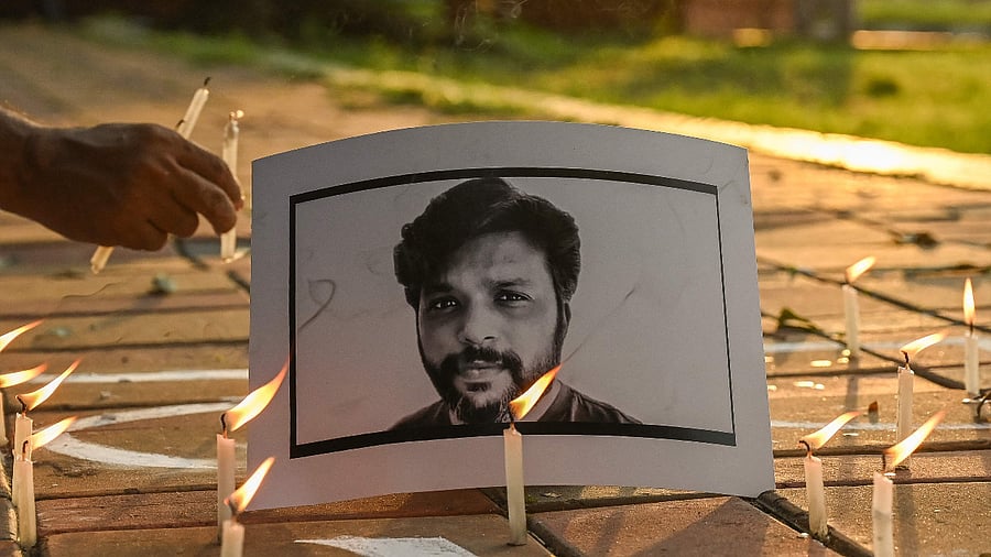 Candles are placed by journalists next to the portrait of Reuters journalist Danish Siddiqui as a tribute in Kolkata. Credit: AFP Photo