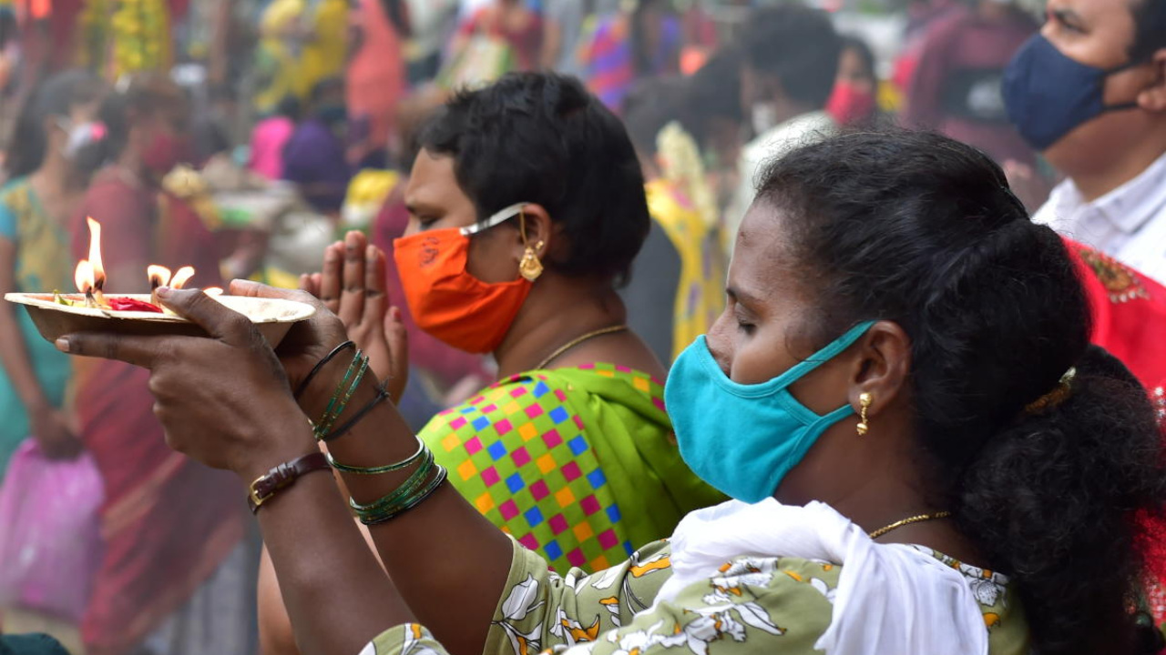 Devotees offer prayers outside the Banshankari Temple during Covid-induced lockdown, in Bengaluru. Credit: PTI Photo