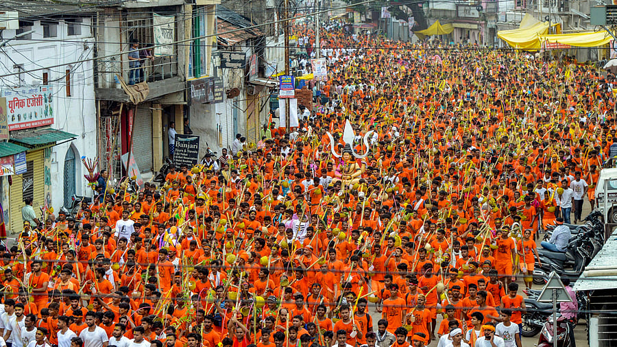 Shiva devotees 'kawadiyas' arrive after they collect Narmada water to perform rituals during the holy month of 'Shrawan', in Jabalpur. Credit: PTI File Photo