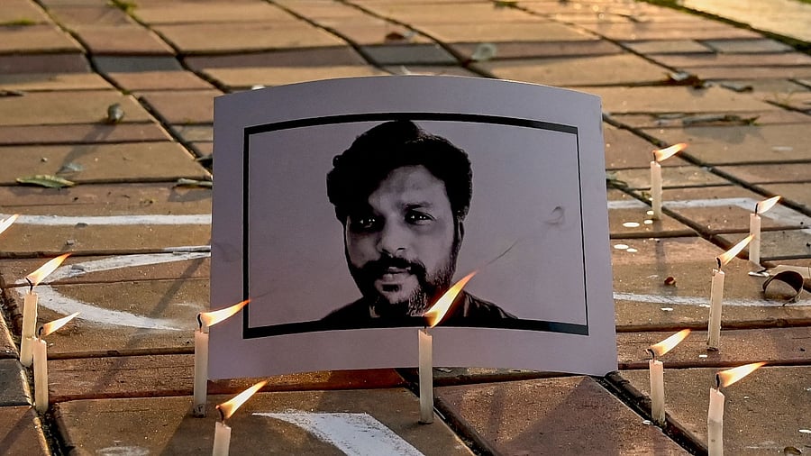 Candles are placed by journalists next to the portrait of Reuters journalist Danish Siddiqui as a tribute in Kolkata. Credit: AFP Photo