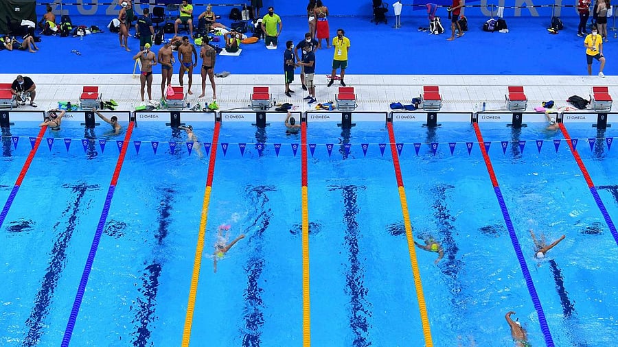An overview shows athletes as they take part in a practice session in the swimming pool at the Tokyo Aquatics Centre. Credit: AFP Photo