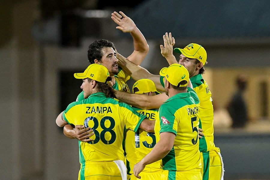 Mitchell Starc (L) of Australia celebrates with teammates winning the 4th T20I between Australia and West Indies at Darren Sammy Cricket Ground, Gros Islet, Saint Lucia. Credit: AFP Photo