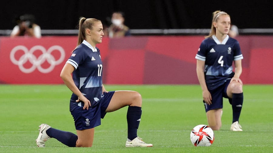 Britain's forward Georgia Stanway (L) and Britain's midfielder Keira Walsh take a knee before the Tokyo 2020 Olympic Games women's group E first round football match between Great Britain and Chile at the Sapporo Dome in Sapporo. Credit: AFP Photo