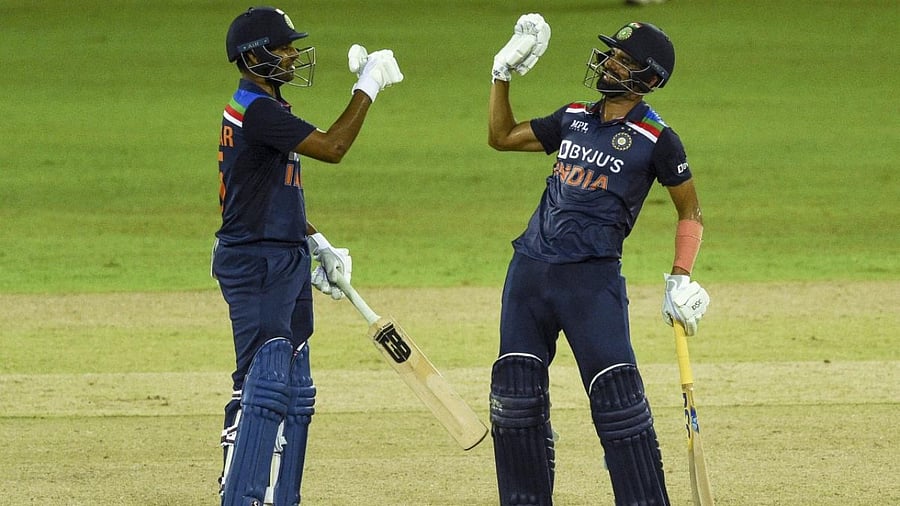 India's Deepak Chahar (R) and Bhuvneshwar Kumar gesture during the second one-day international (ODI) cricket match between Sri Lanka and India at the R.Premadasa Stadium in Colombo. Credit: AFP Photo