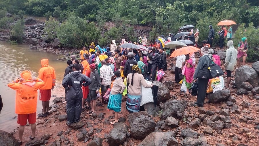This handout picture taken and released by the NDRF shows NDRF personnel rescuing stranded villagers from the low lying areas which were flooded after heavy rains. Credit: AFP Photo/NDRF