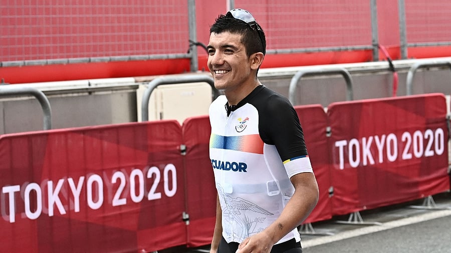 Gold medallist Ecuador's Richard Carapaz walks to the podium for the medal ceremony of the men's cycling road race of the Tokyo 2020 Olympic Games. Credit: AFP Photo