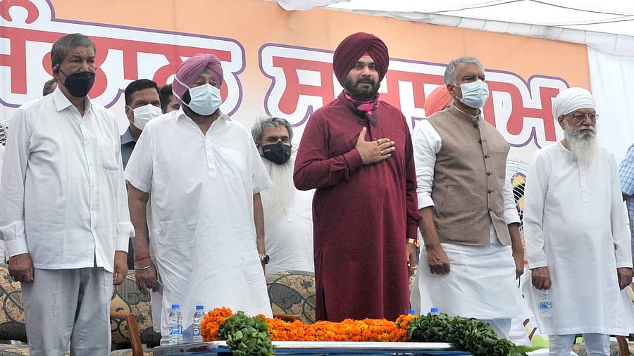 Newly appointed Punjab Congress President Navjot Singh Sidhu (C) with Punjab CM Capt. Amrinder Singh (2nd from left). Credit: PTI Photo