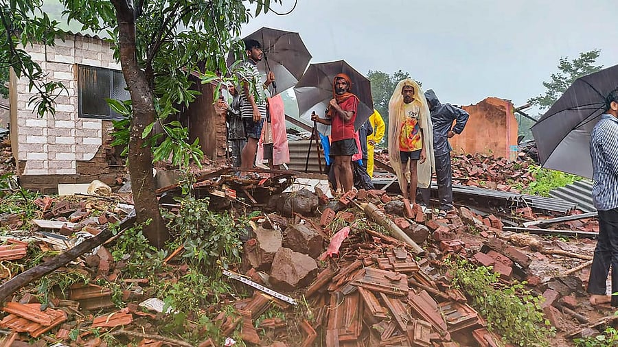 Locals at the site after several people died in a landslide in Satara district. Credit: PTI Photo