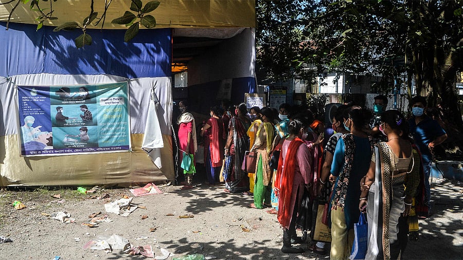 Women wait in a queue to register their children aged 0-12 years for a dose of the Covishield vaccine at a primary health centre in Siliguri. Credit: AFP Photo