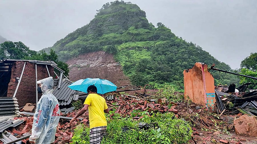 Locals at the site after several people died in a landslide at Taliye village in Satara district, Friday. Credit: PTI Photo