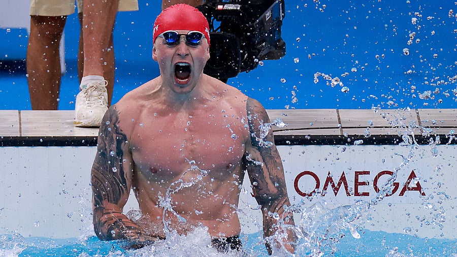 Britain's Adam Peaty celebrates winning to take gold in the final of the men's 100m breaststroke swimming event. Credit: AFP Photo