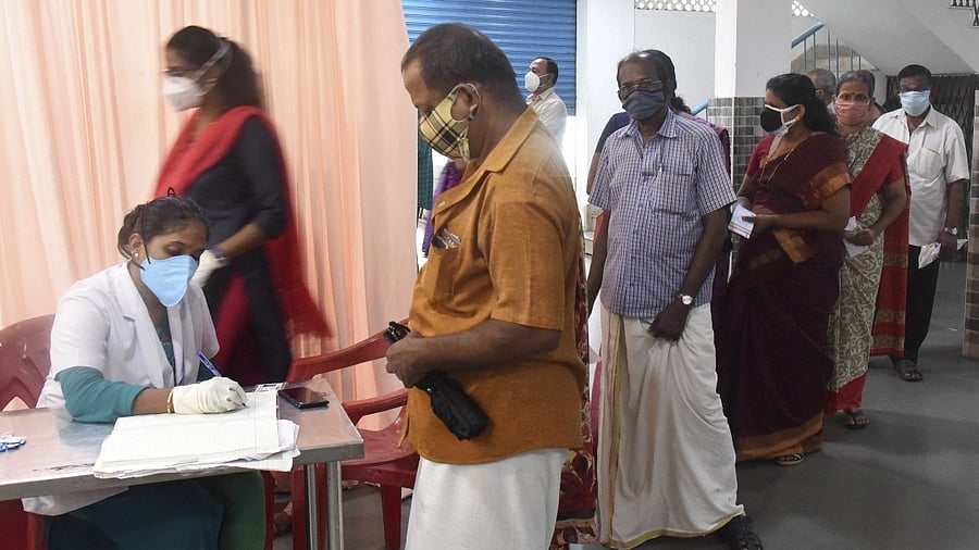 Beneficiaries wait to receive a dose of Covid-19 vaccine at a vaccination centre in Kochi. Credit: PTI file photo