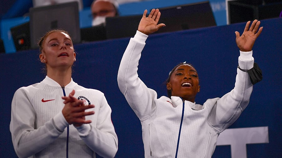 USA's Grace Mc Callum and Simone Biles. Credit: AFP Photo