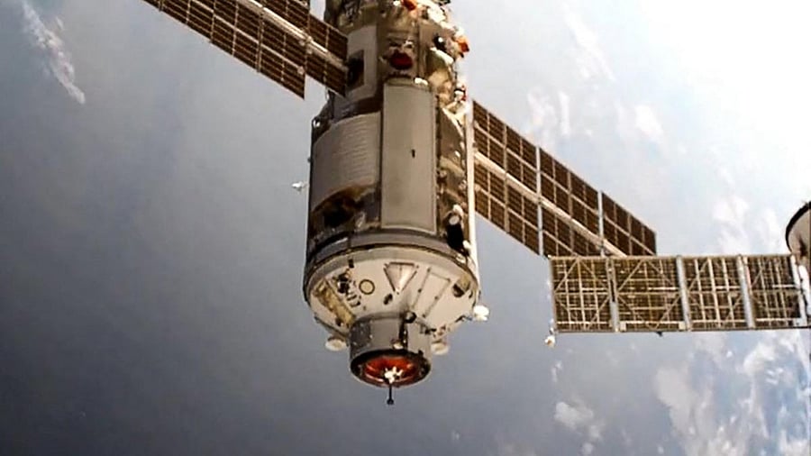 This handout photograph taken and released by the Russian Space Agency Roscosmos on July 29, 2021, shows the Russian Multipurpose Laboratory Module "Nauka" (Science) docking to the International Space Station (ISS). Credit: AFP Photo/Roscosmos