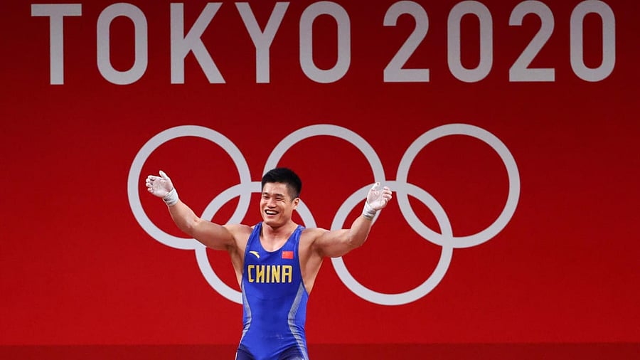 Xiaojun Lyu of China celebrates after a lift. Credit: Reuters Photo