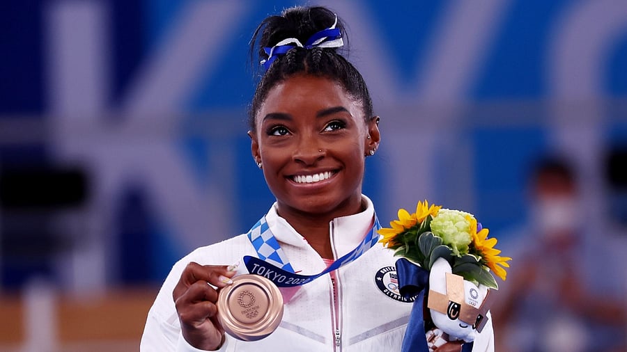 American gymnast poses with the Olympic bronze medal for the beam event. Credit: Reuters Photo