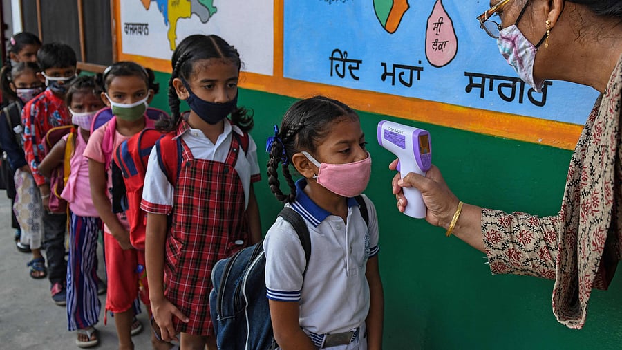 Given the primacy that schooling deserves, teachers and staff ought to have been treated as priority categories for vaccination early on. Screening and managing sick students, teachers, and other school staff and enforcing the "staying at home if unwell" policy is singularly important. Credit: AFP Photo/ Representative