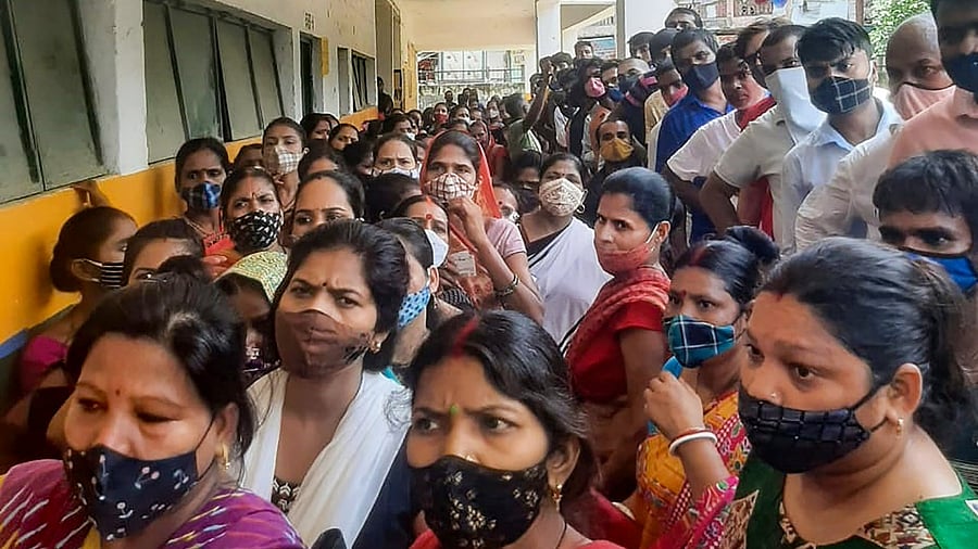 Beneficiaries wait to receive Covid-19 vaccine dose, at a govt school turned vaccination centre in Noida. Credit: PTI Photo
