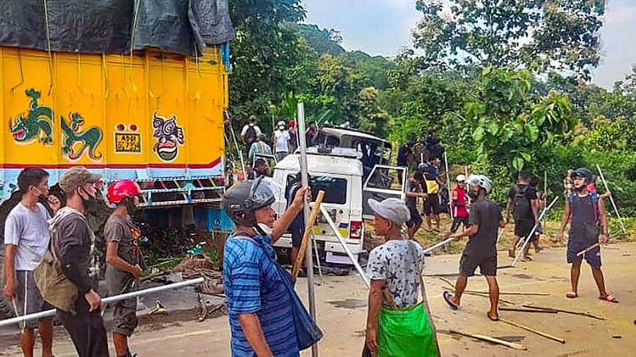 Locals near damaged security force vehicles after clashes last night on the Assam-Mizoram border at Lailapur in Cachar district. Credit: PTI file photo