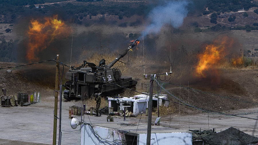 Israeli forces fire artillery from their position on the border with Lebanon after a barrage of rockets were fired from Lebanon. Creidt: AP Photo