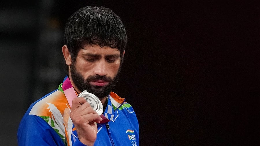 Dahiya holds his Olympic silver medal. Credit: PTI Photo