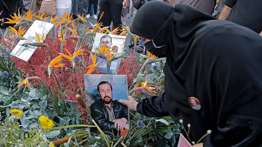 Families of the August 4 victims joined by protestors march with replica coffins and portraits of their loved ones during a symbolic funeral procession from Beirut port. Credit: AFP Photo