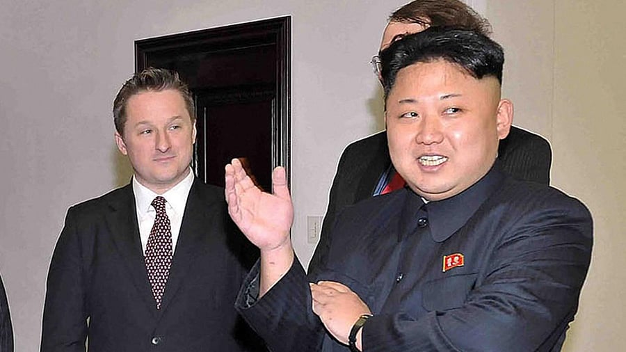 North Korean leader Kim Jong Un (R) chatting during a visit by former US basketball star Dennis Rodman (not pictured), as Canadian businessman Michael Spavor (L) looks on. Credit: AFP Photo