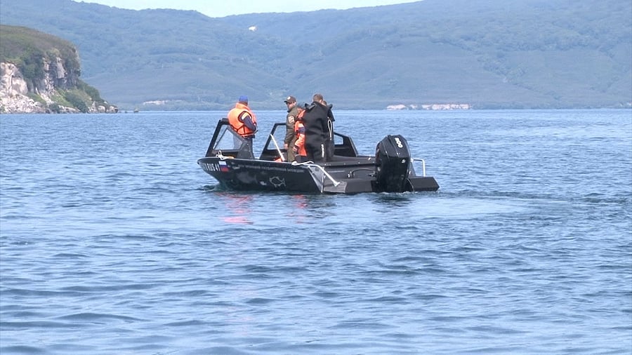 Emergency specialists conduct a search and rescue operation after a helicopter carrying 16 people, most of them tourists, crashed in Kurilskoe lake, in Kamchatka. Credit: Reuters photo/Emergencies Ministry/Handout