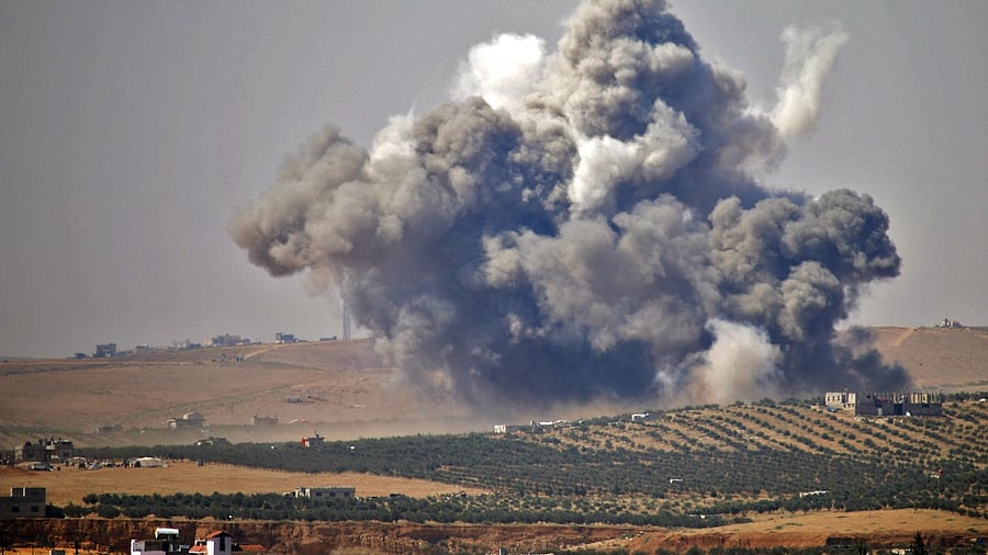 Smoke rises above rebel-held areas of the city of Daraa. Credit: AFP File Photo