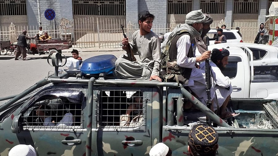 Taliban fighters are pictured in a vehicle of Afghan National Directorate of Security (NDS) on a street in Kandahar. Credit: AFP Photo