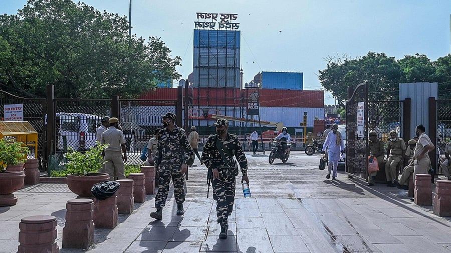 Security personnel patrol near the containers stacked in front of the Red Fort. Credit: AFP Photo