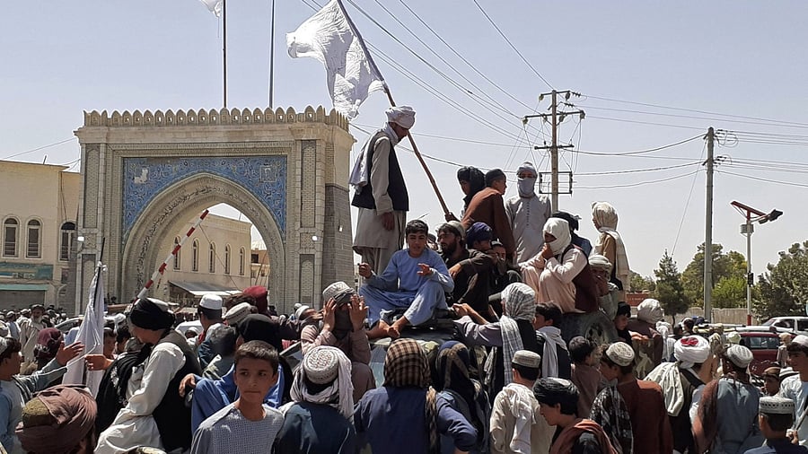 Taliban fighters stand on a vehicle along the roadside in Kandahar. Credit: AFP Photo