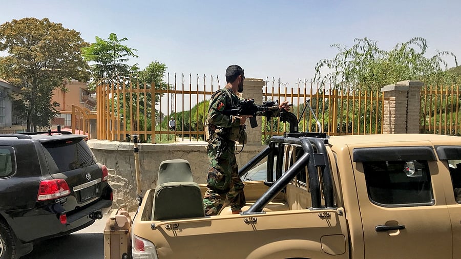 An Afghan soldier stands in a military vehicle on a street in Kabul. Credit: Reuters Photo
