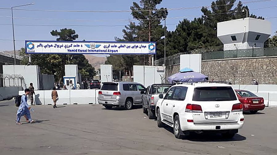 Afghan police check the cars at the entrance gate of Hamid Karzai International Airport. Credit: Reuters Photo
