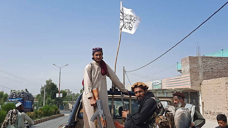Taliban fighters drive an Afghan National Army (ANA) vehicle. Credit: AFP photo