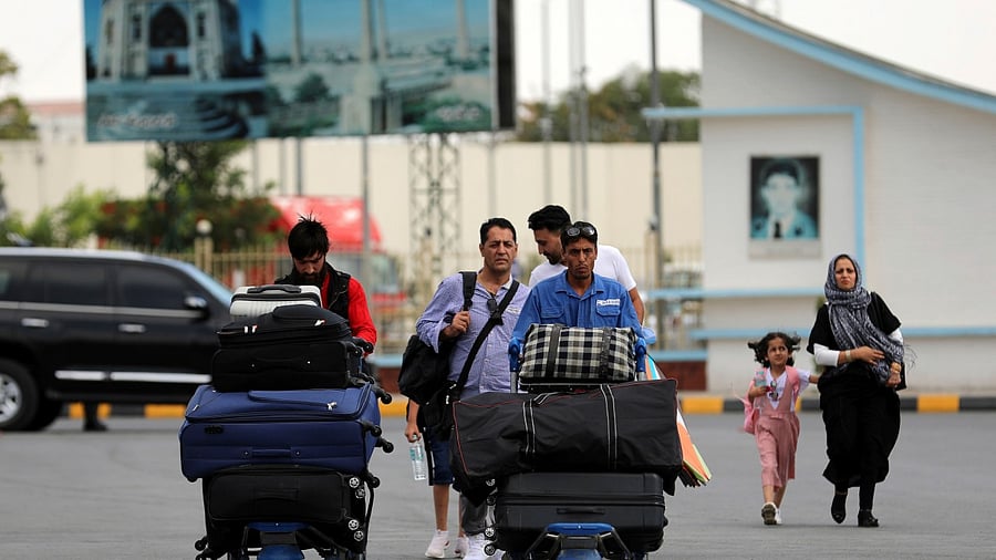 Passengers walk to the departures terminal of Hamid Karzai International Airport in Kabul. Credit: AP Photo