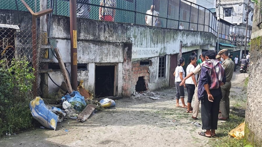 Police personnel stand near the site of an IED blast at Laitumkhrah market in Shillong, Tuesday, August 10, 2021. Credit: PTI Photo