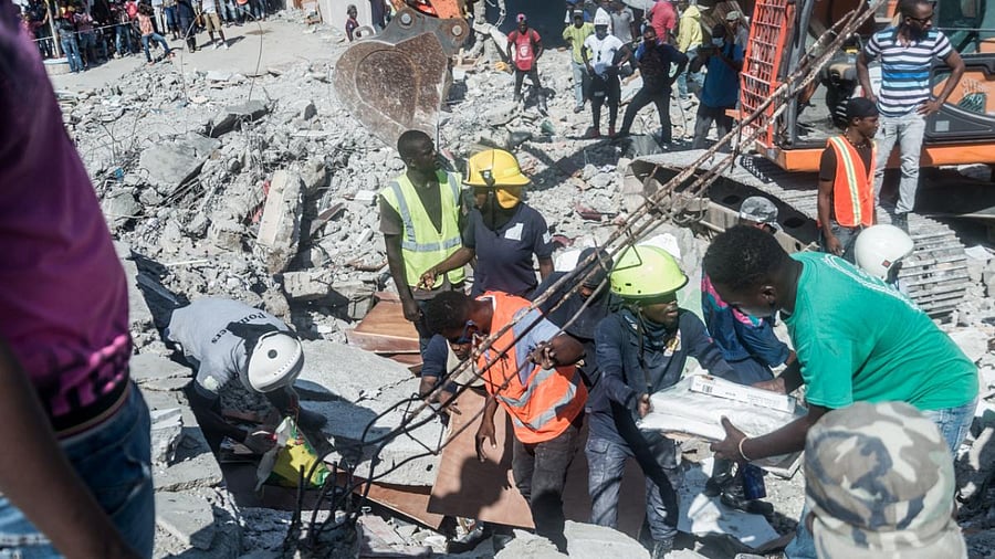 People look for survivors amongst the rubble in the neighbourhood of Dexia 6, Les Cayes, Haiti. Credit: AFP Photo